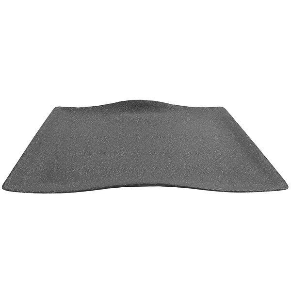 A black rectangular cheforward melamine platter with a curved edge.