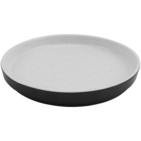 A white round melamine plate with a black and white rim.