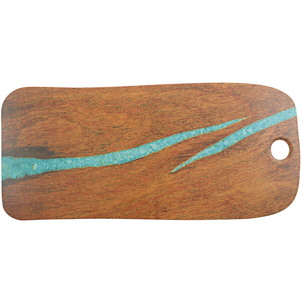 A cheforward wooden rectangle serving board with blue and green streaks.