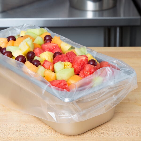 A tray of fruit in a plastic bag lined with a nylon pan liner.