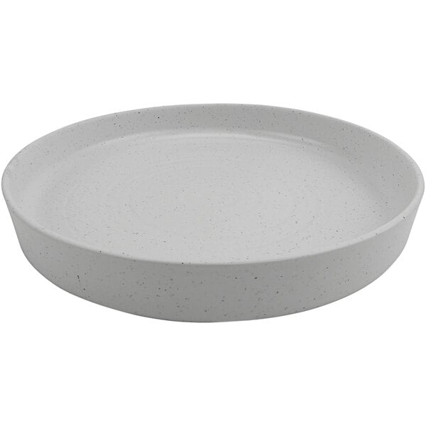 A white round melamine platter with a speckled edge.