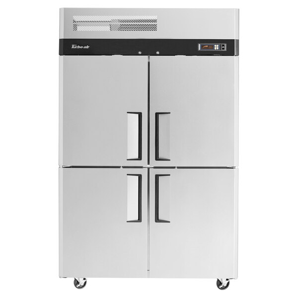 A white Turbo Air reach-in refrigerator with black handles on half doors.
