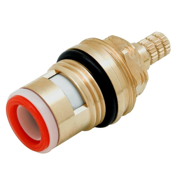A brass and red ceramic cartridge assembly for a faucet.
