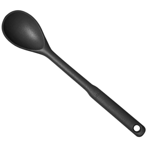 An OXO Good Grips black silicone spoon with a hole in the handle.