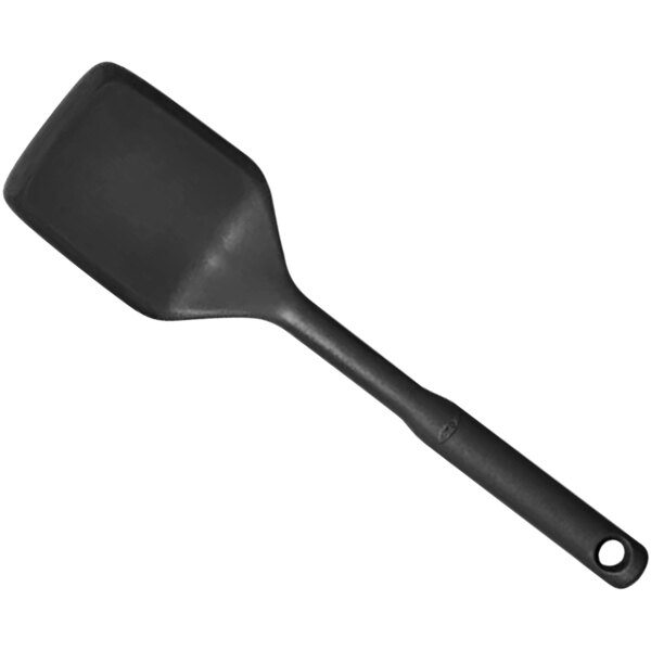 An OXO Good Grips black silicone spatula with a long handle.