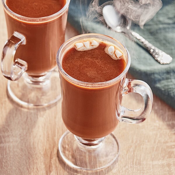 Two glass mugs of Ghirardelli Mocha hot chocolate with marshmallows.
