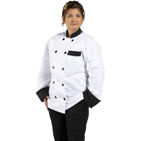 A woman wearing a Uncommon Chef Newport white chef coat with black trim.