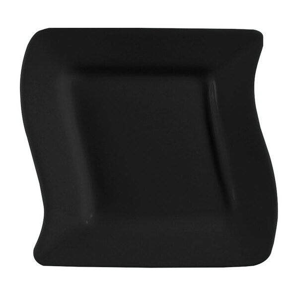 A black square stoneware plate with a curved edge.