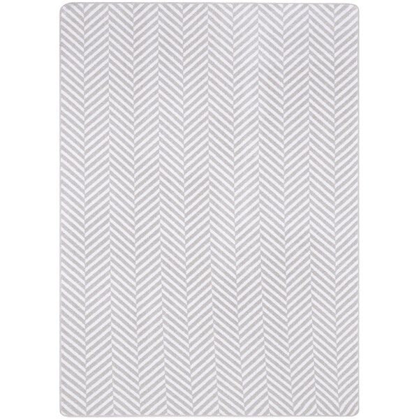 A white rectangular Joy Carpets area rug with a grey chevron pattern.