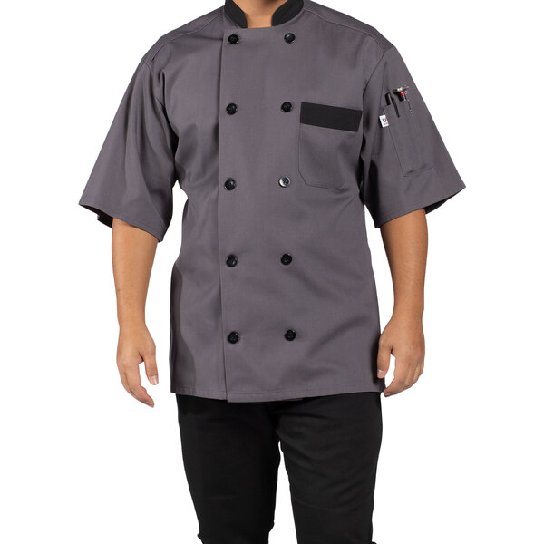 A man wearing a slate gray Uncommon Chef short sleeve chef coat with black trim.