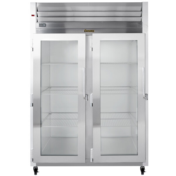 A Traulsen reach-in refrigerator with two glass doors and glass shelves.