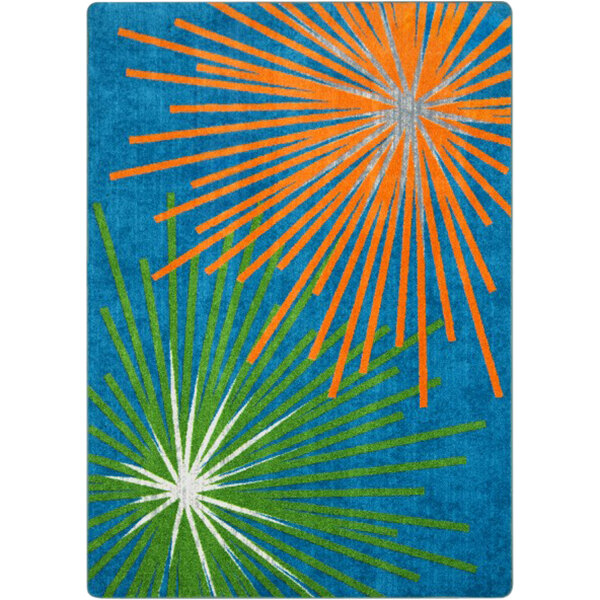 A green and blue rug with orange, blue, and green starbursts.