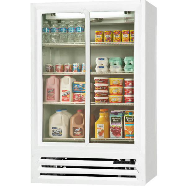 A white Beverage-Air merchandiser with dairy products and drinks behind a glass door.
