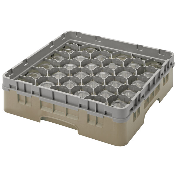 A beige plastic rack with many compartments and extenders with many holes.