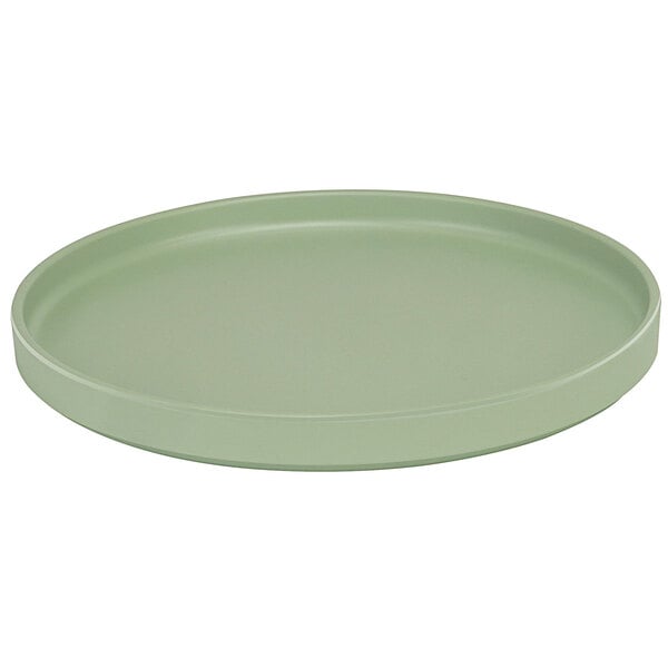 A green round Cal-Mil Melamine plate with a low rim.