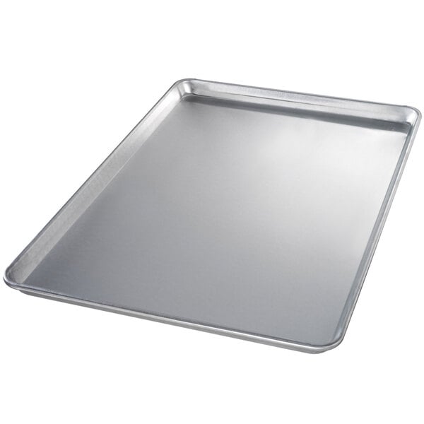 A Chicago Metallic aluminum bun pan with a semi-curled rim on a counter.