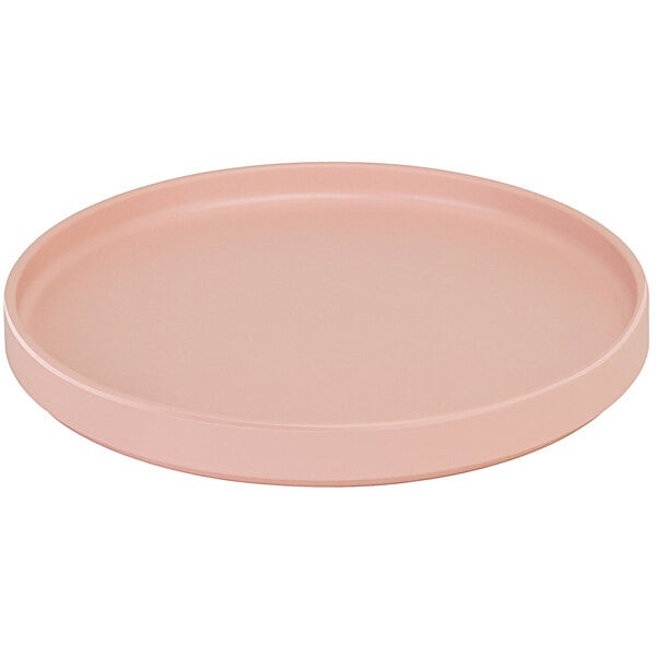 A Cal-Mil blush pink melamine plate with a low rim.