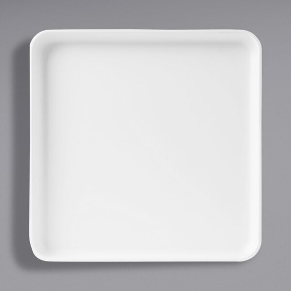 A Cal-Mil white square melamine plate with a raised rim.