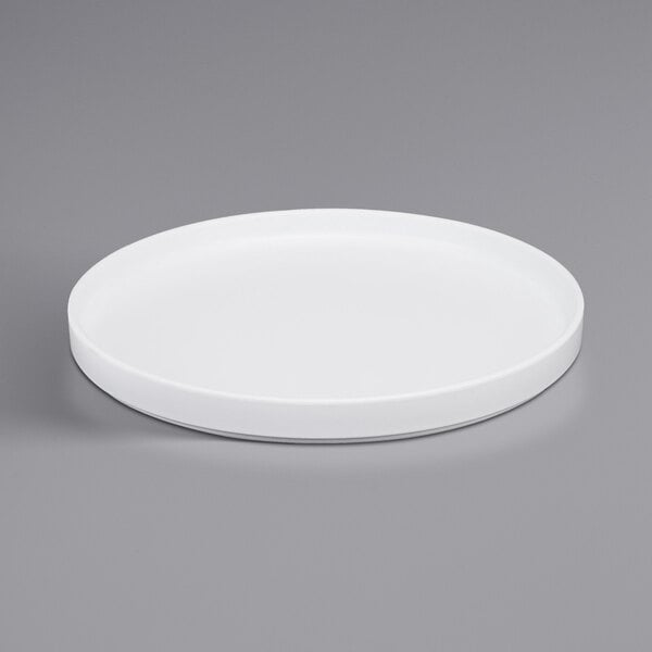 A white Cal-Mil melamine plate with a low rim.