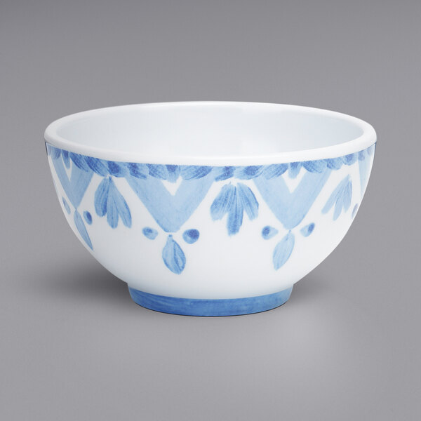 A white melamine bowl with a blue and white painted surface.