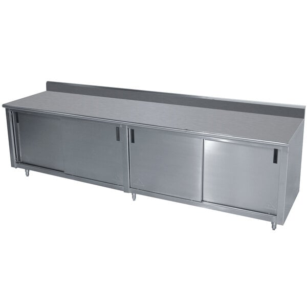 A stainless steel kitchen counter with a cabinet and mid shelf.