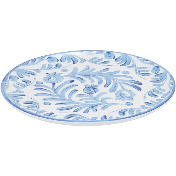 A close-up of a Cal-Mil Costa blue and white melamine plate with a floral design.