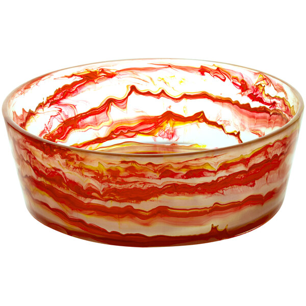 A Bon Chef round resin bowl with red and white swirls on a counter.
