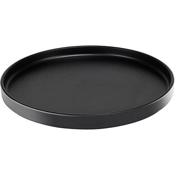 A black round Cal-Mil Hudson melamine plate with a low rim.
