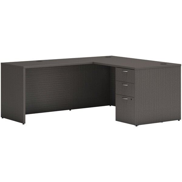 A black Hon L-station desk with drawers and a cabinet.