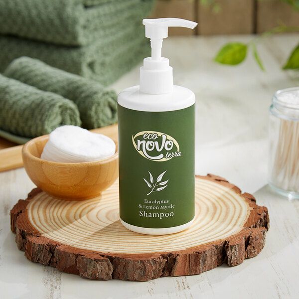 A green Noble Eco Novo Terra shampoo bottle with a white cap on a wood slice.