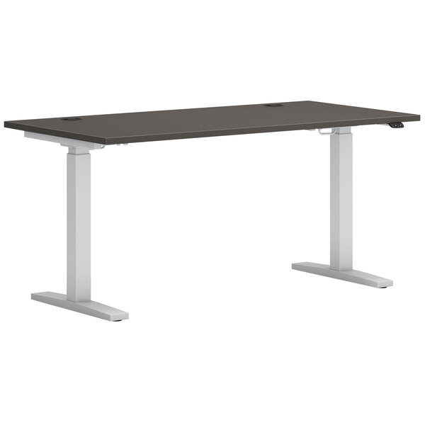 A black rectangular Hon Mod height-adjustable desk with silver legs.