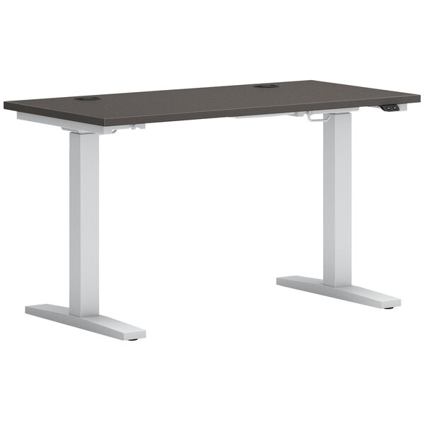 A black and white Hon Mod height-adjustable desk with a black top and white base.