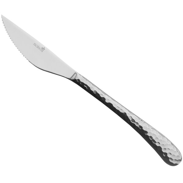 A Sola stainless steel steak knife with a textured black handle.