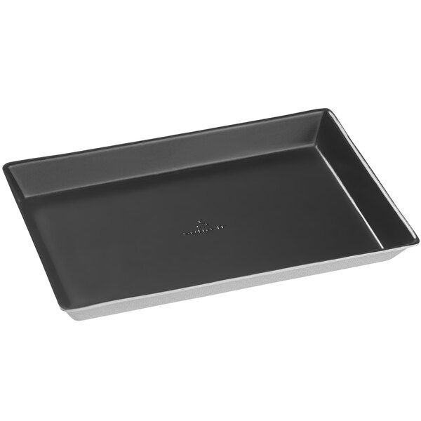 A Solia rectangular black plate with a silver handle.