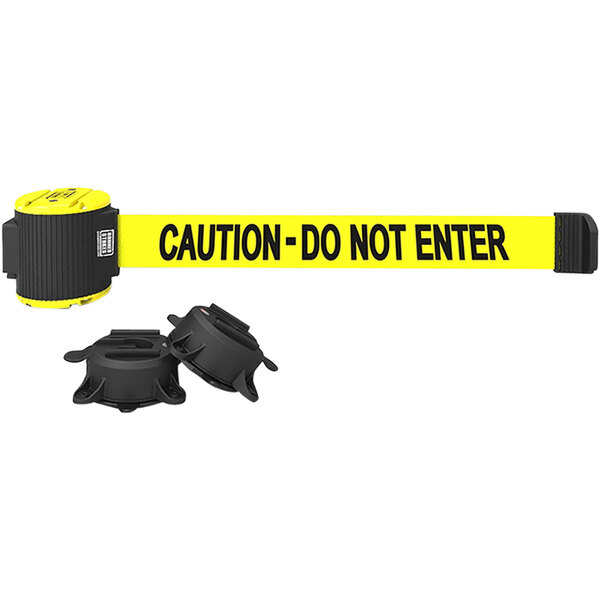 A yellow Banner Stakes wall mount belt barrier with black text on yellow tape.