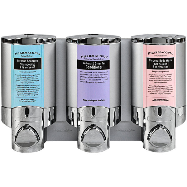 A chrome Dispenser Amenities wall mounted soap dispenser with three satin silver bottles.