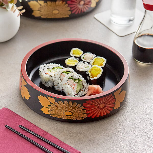 An Emperor's Select black sushi tray with red rim holding sushi on a table.