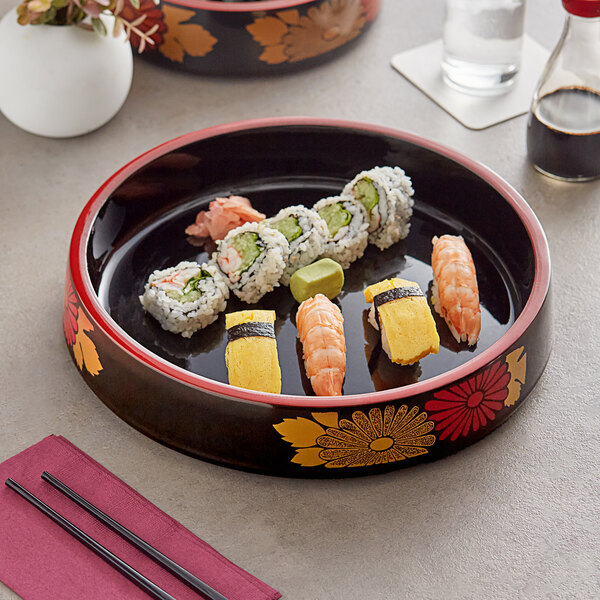 A black Emperor's Select sushi tray with red rim holding sushi on a table.