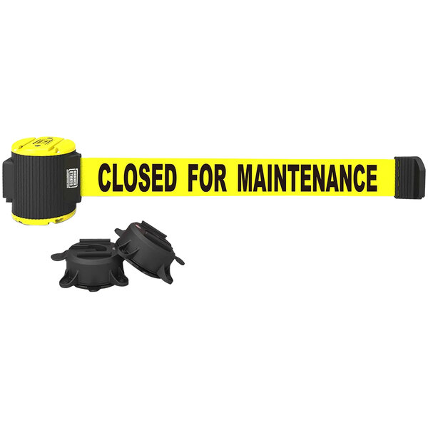 A yellow Banner Stakes magnetic wall mount barrier with black text reading "Closed for Maintenance" hanging on a white wall.