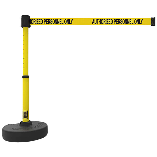 A yellow and black Banner Stakes PLUS retractable barrier with a yellow sign on it.