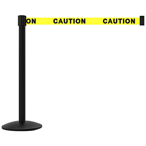 A yellow caution banner on a black pole with a black base.