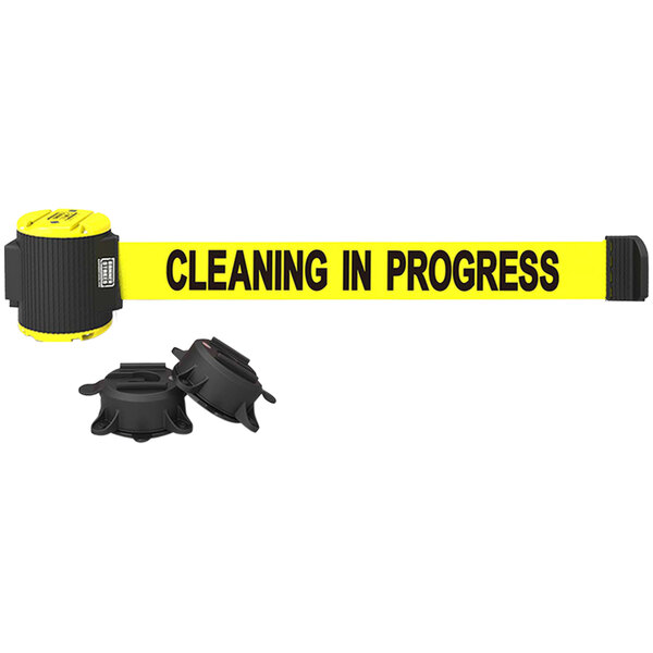 A Banner Stakes yellow wall mount belt barrier with black text reading "Cleaning in Progress" and black and yellow magnetic ends.