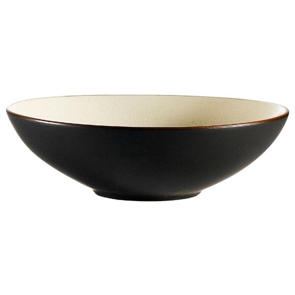 A black stoneware bowl with a creamy white rim.