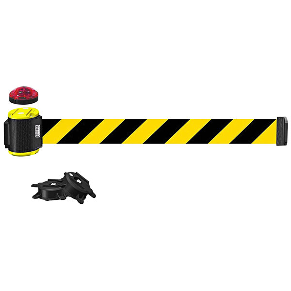 A black and yellow Banner Stakes wall mount barrier with a red light.