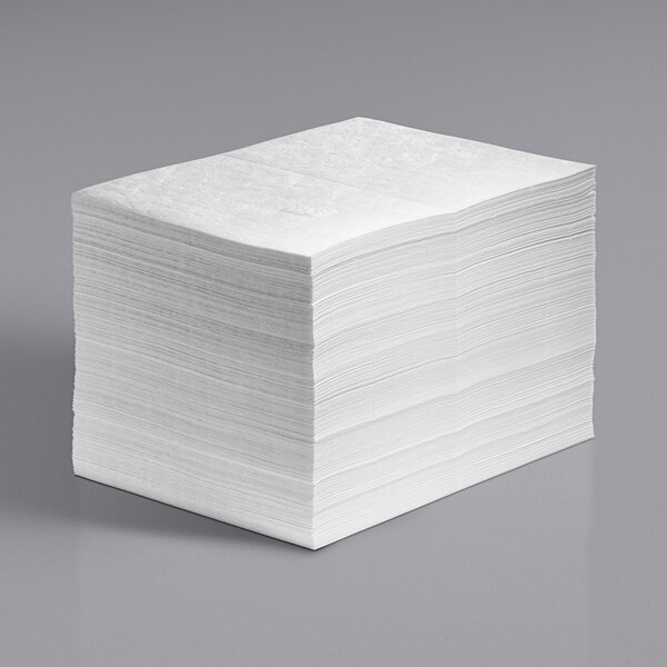 A stack of white New Pig oil absorbent mat pads.