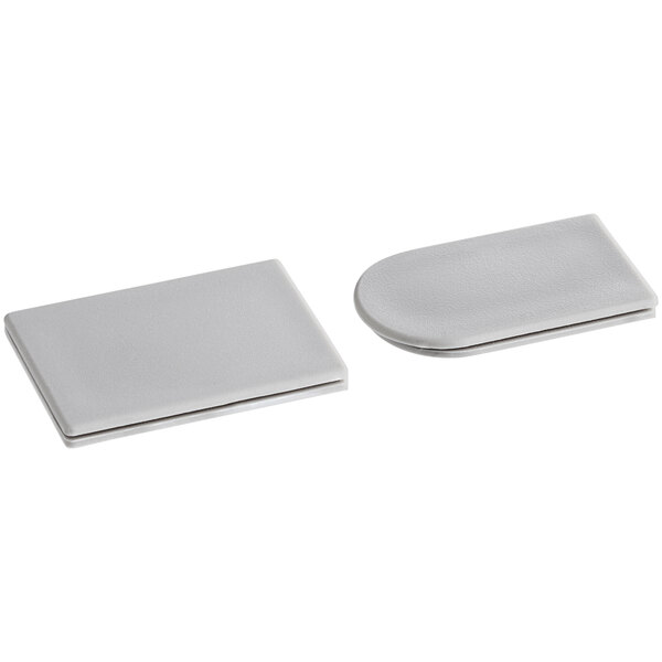 Two silver metal rectangular plates with a white background.