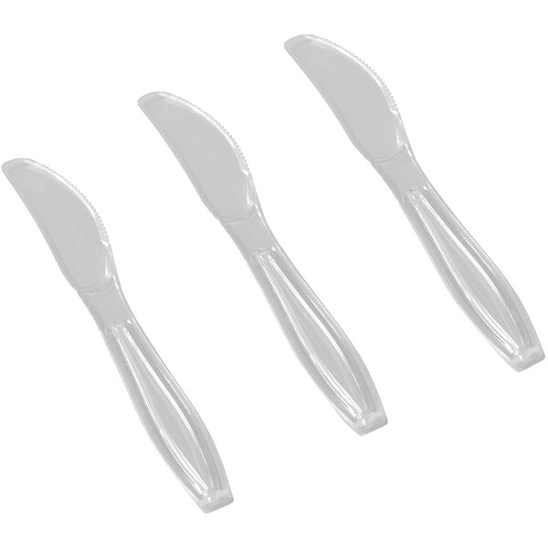 A close-up of three Fineline Flairware plastic knives.