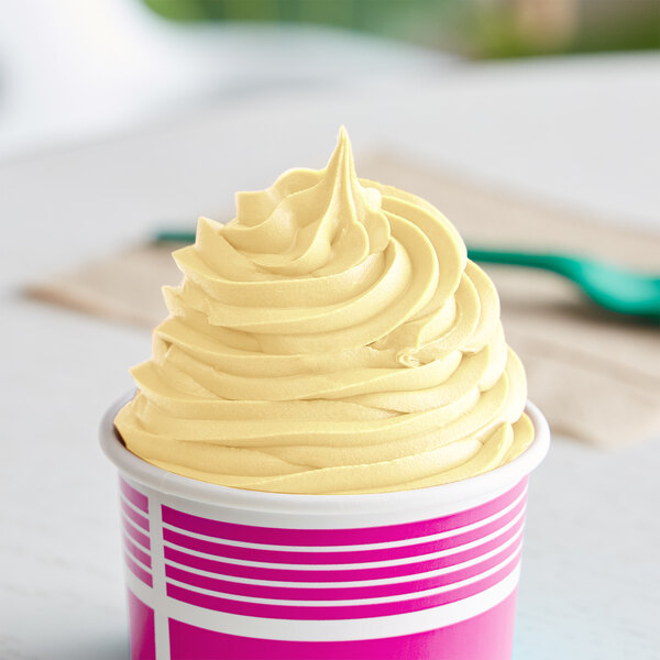 A cup of Dannon YoCream frozen yogurt with a yellow swirl on top.