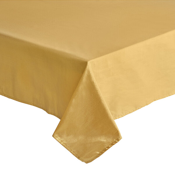 A gold Amscan rectangular tablecloth on a table.