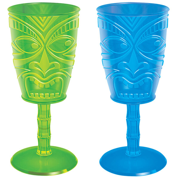 Two green plastic wine glasses with tiki faces on the base.